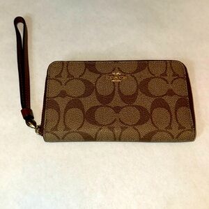 Coach brown canvas wallet with wrist strap